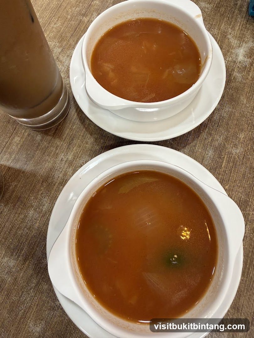 Two bowls of soup and a drink