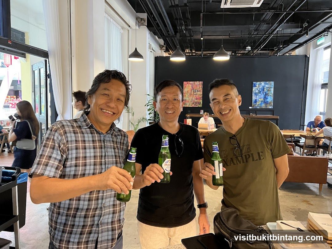 Three men holding beer bottles