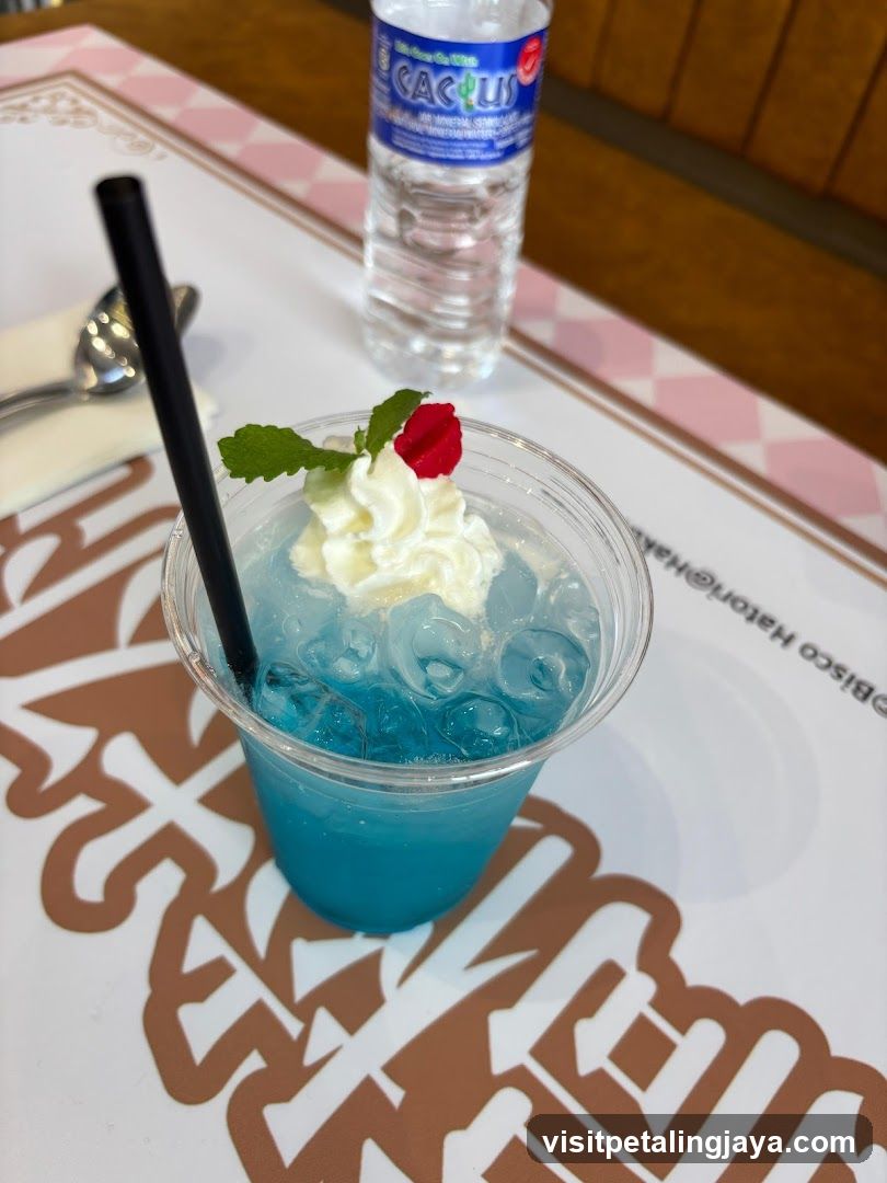 Blue Drink with Whipped Cream and Ice Cubes