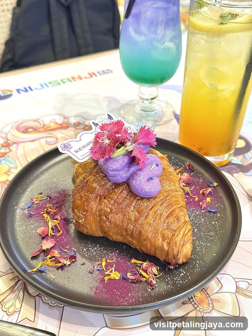 Croissant with purple topping and colorful drinks