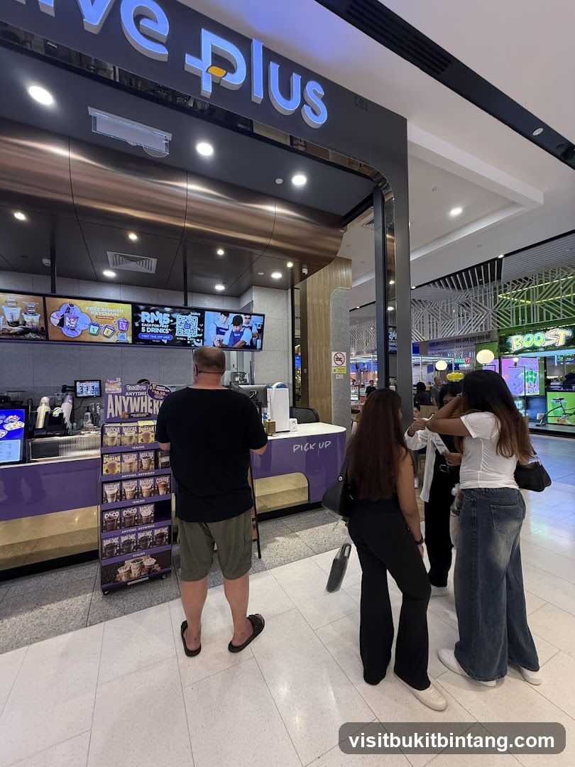 People ordering at a cafe counter