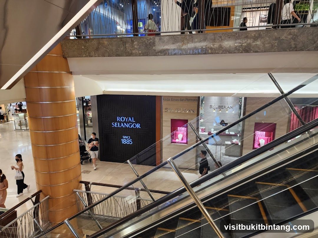 Interior of a shopping mall with escalators and storefronts