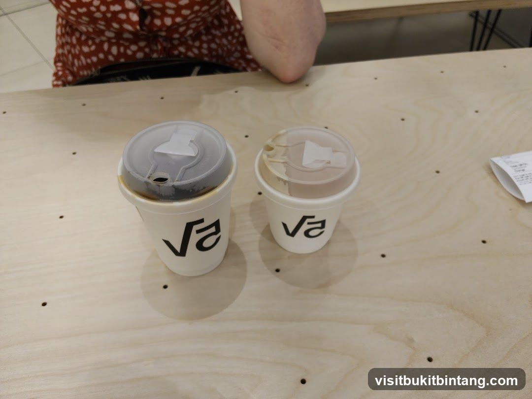 Two coffee cups on a wooden table
