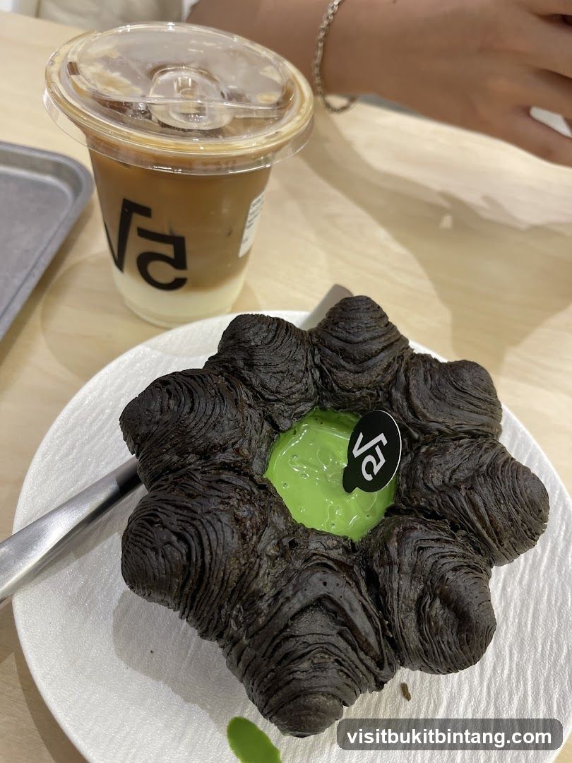 Dark Croissant with Green Filling and Iced Coffee
