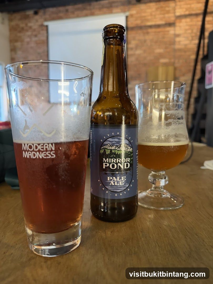 Two glasses of beer and a bottle of pale ale