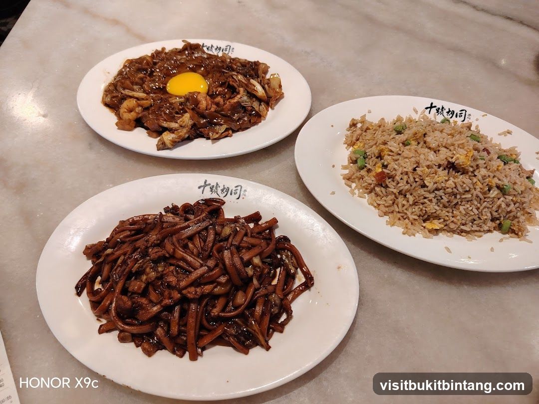 Three Plates of Noodles and Fried Rice
