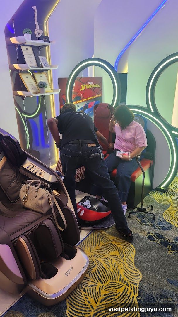 Interior of a modern lounge or spa area with massage chairs and themed decor.