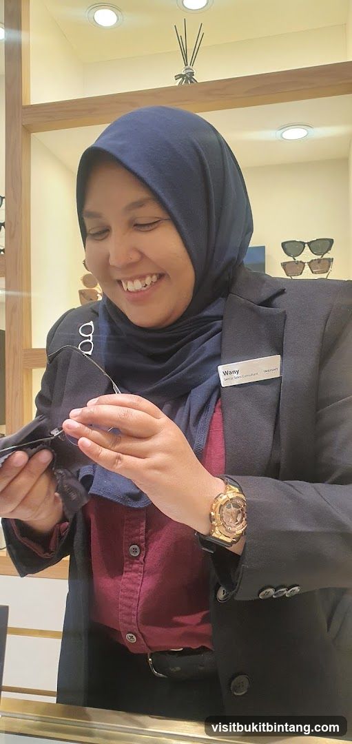 Optician cleaning glasses