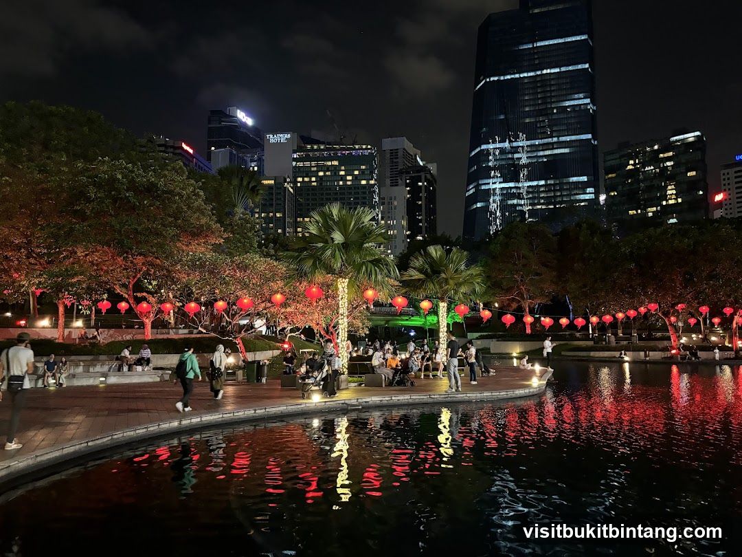 Nighttime park with lanterns and city skyline