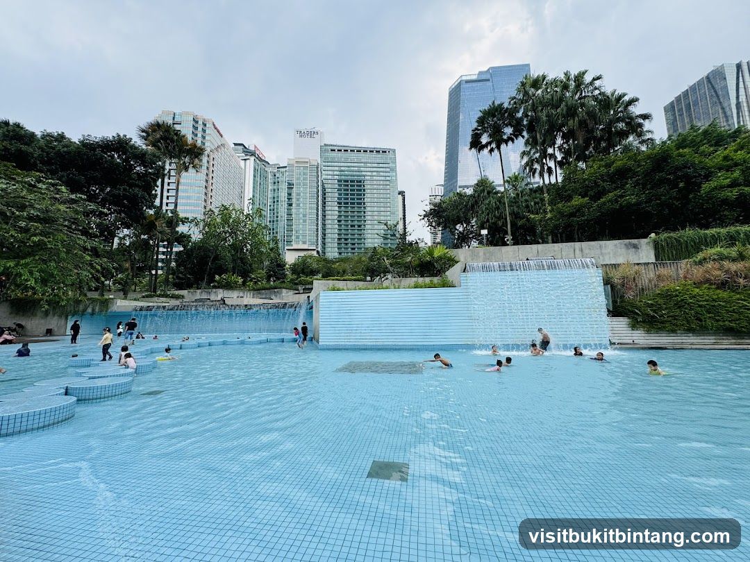 People swimming in a pool with city skyscrapers in the background