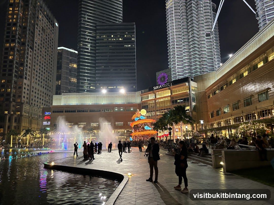 Nighttime view of Suria KLCC with fountains and Petronas Towers
