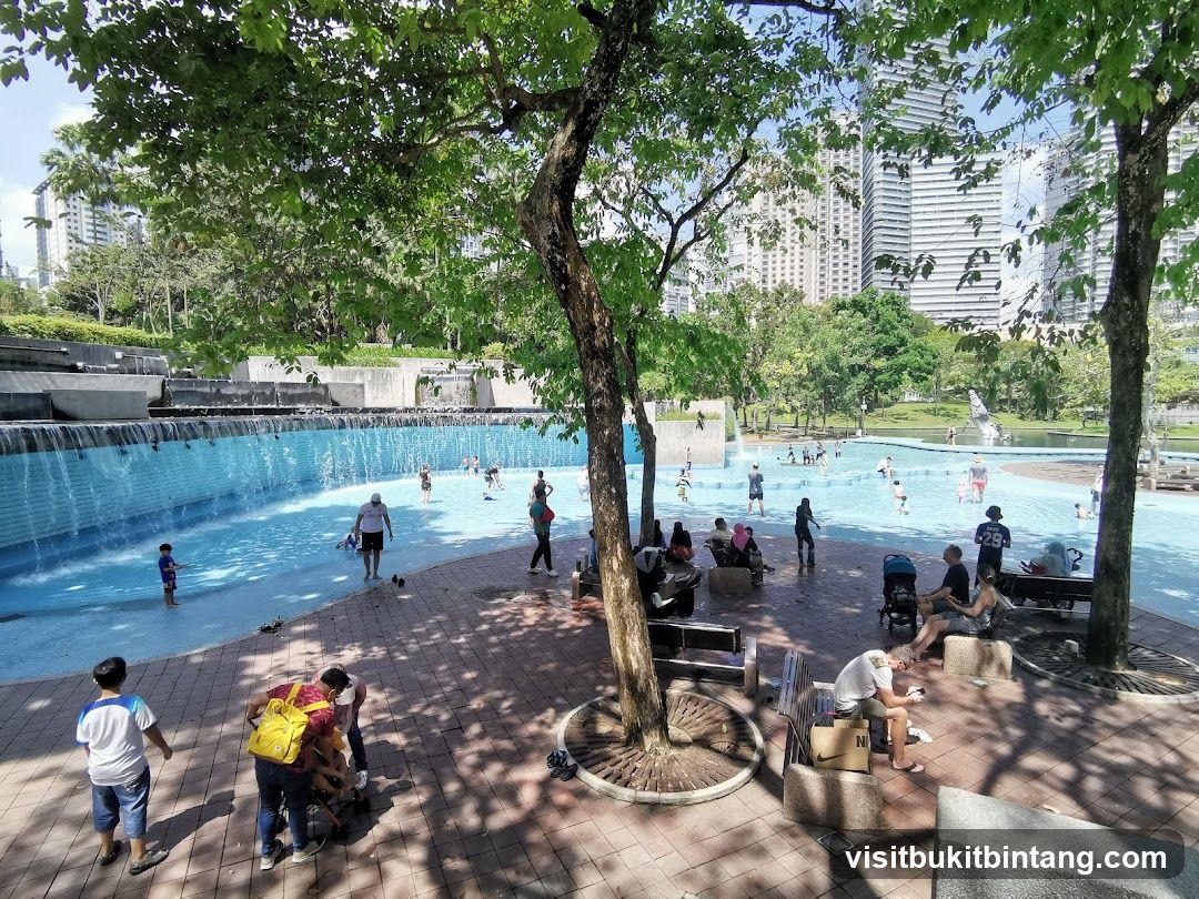 People enjoying a public swimming pool on a sunny day