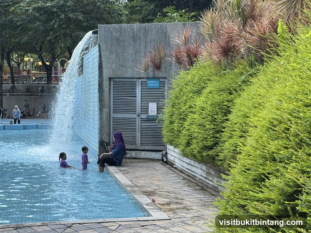 People at a swimming pool with a waterfall