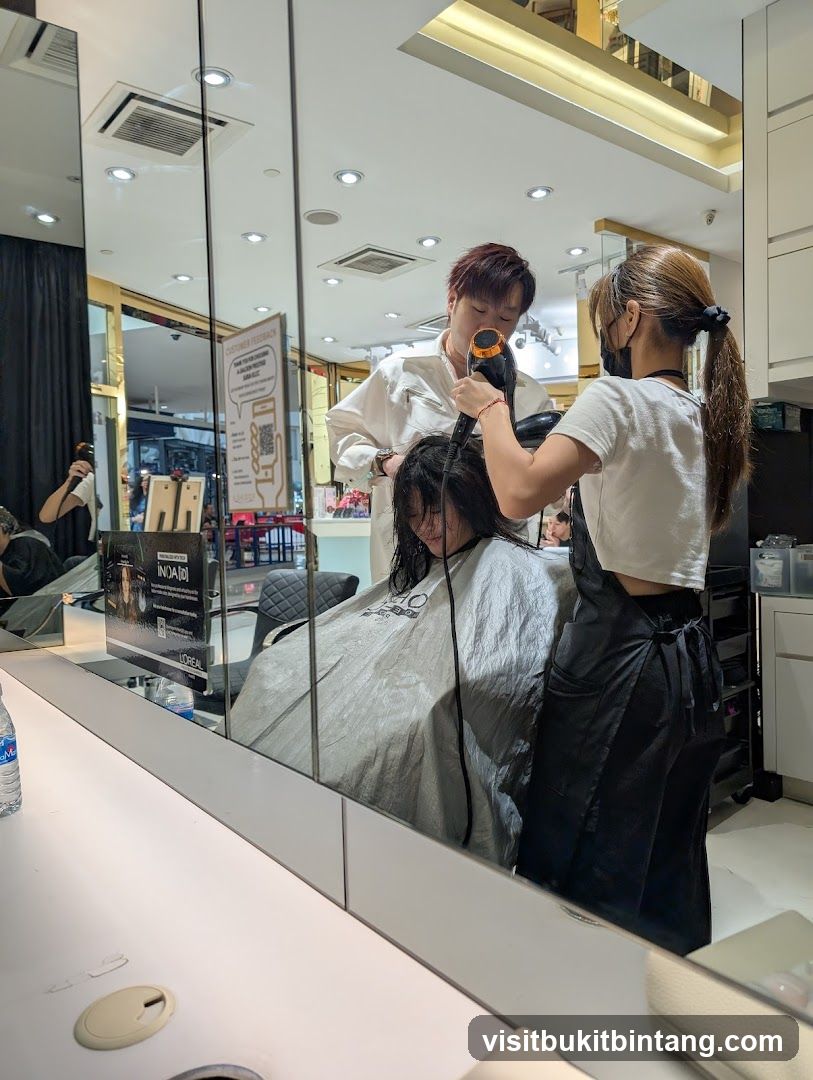Hairdresser drying client's hair