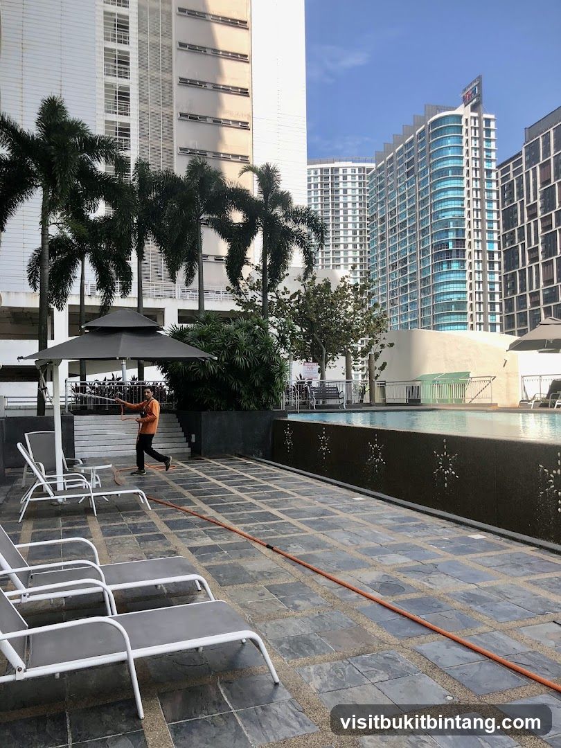 Swimming Pool Area with Lounge Chairs and Buildings