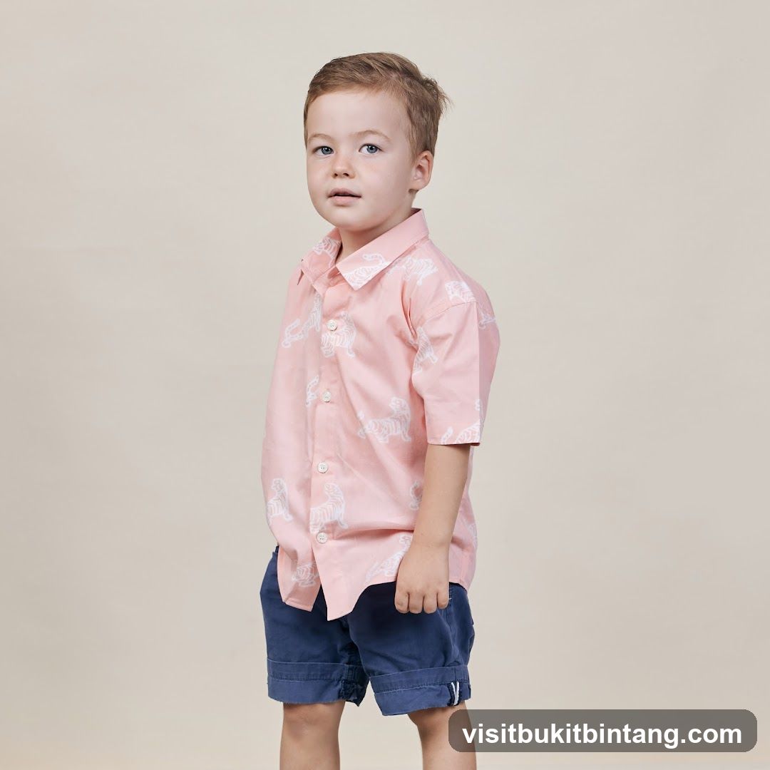 Young Boy in Pink Tiger Print Shirt and Blue Shorts