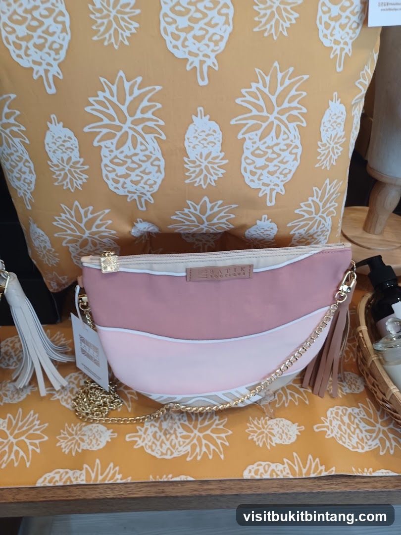 Pink and white handbag with gold chain and tassels