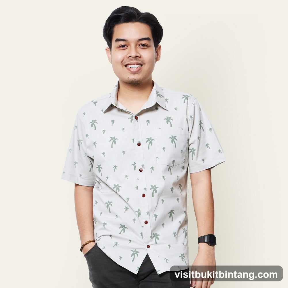Man in a palm tree print shirt