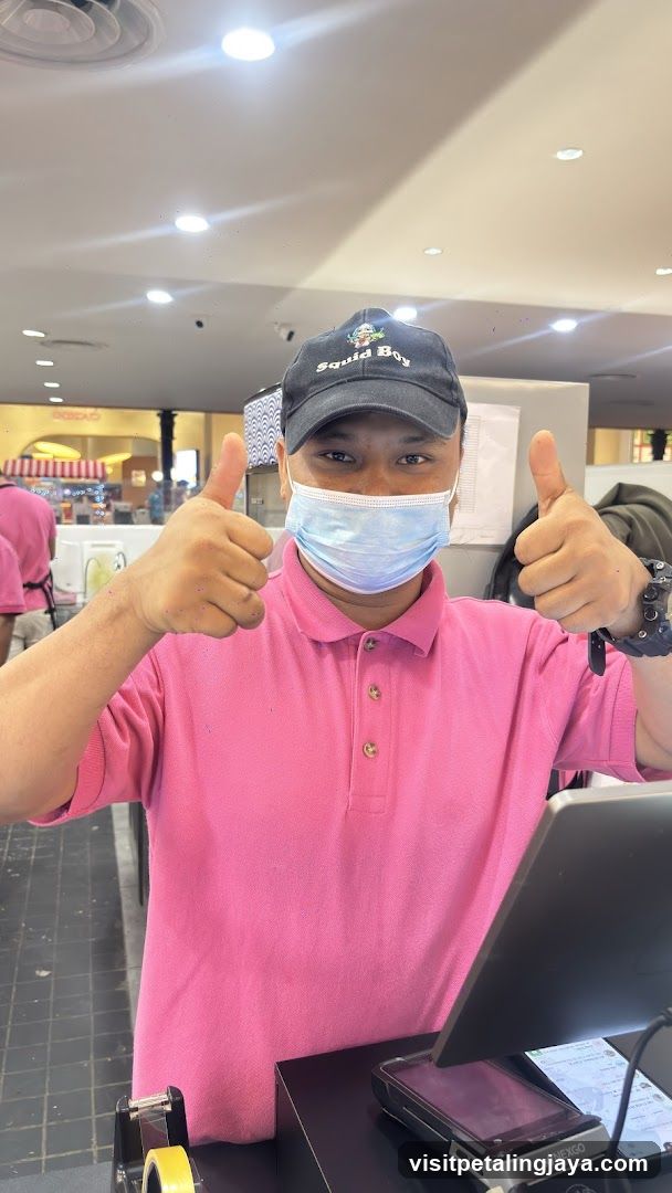 Staff giving thumbs up at counter