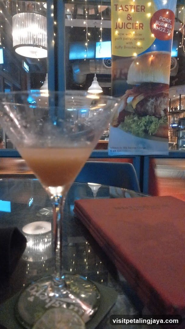 Dining Scene with Cocktail and Menu