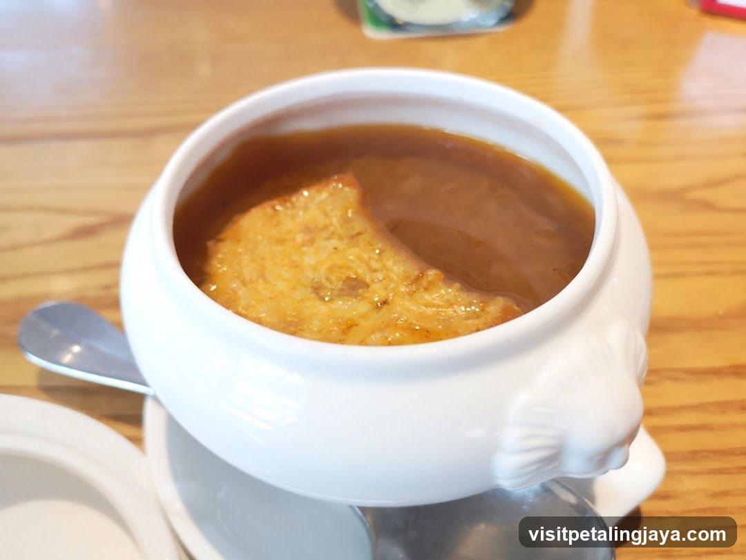 Soup in a white bowl with bread