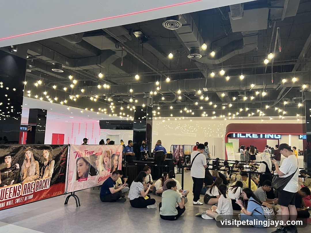 Indoor Event Space with Fans and Merchandise Banners