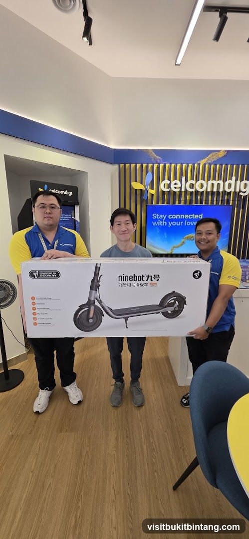 CelcomDigi Staff Presenting a Ninebot Electric Scooter