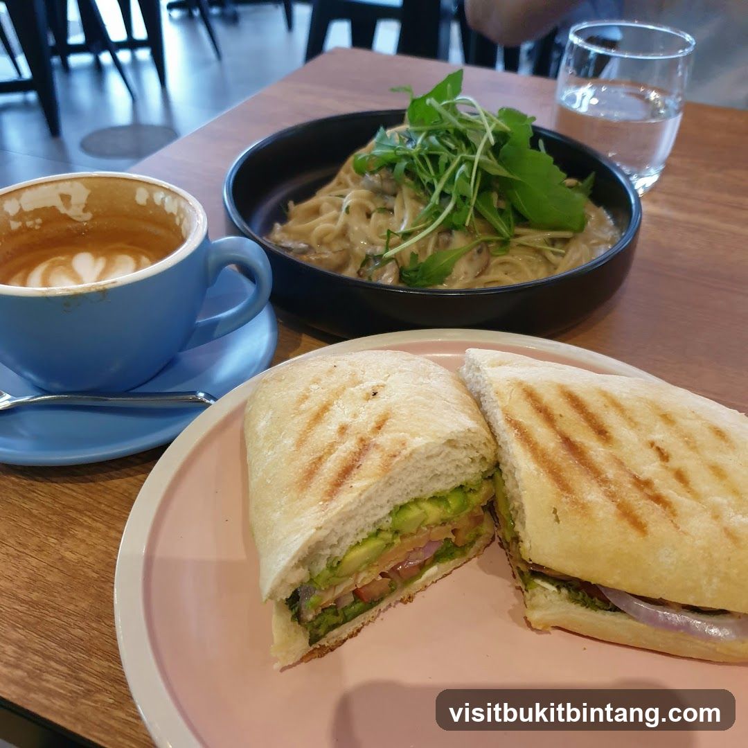 Cafe meal with coffee, pasta, and sandwich