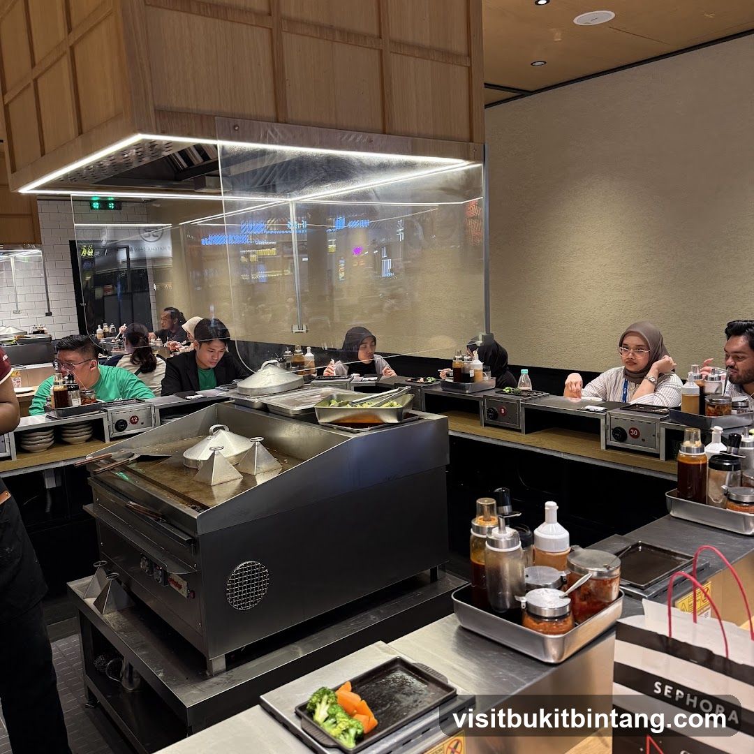 Diners at a Counter with Cooking Station