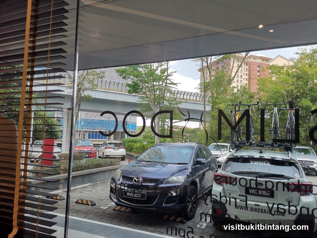 Cars parked outside a building with signage