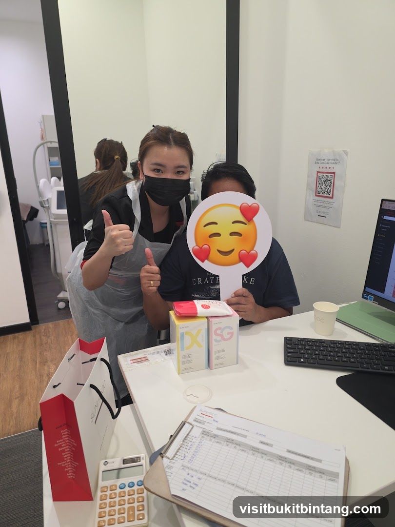Two people posing with a smiley face prop