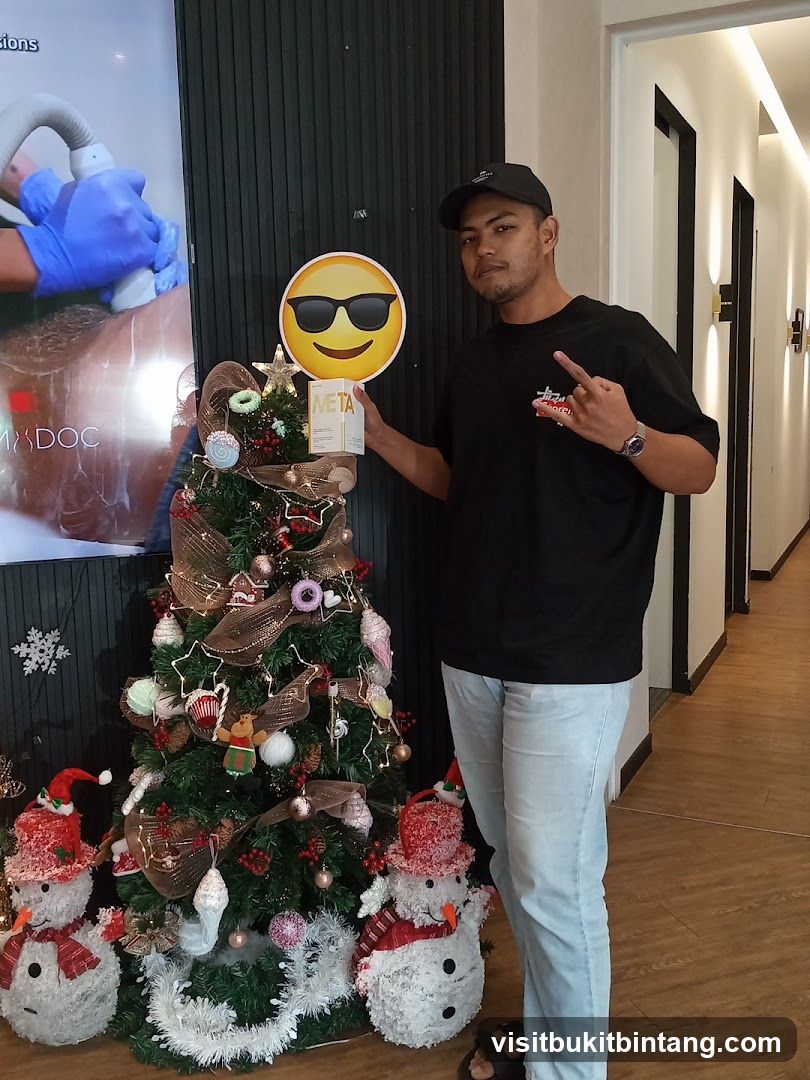 Man holding a product box next to a Christmas tree