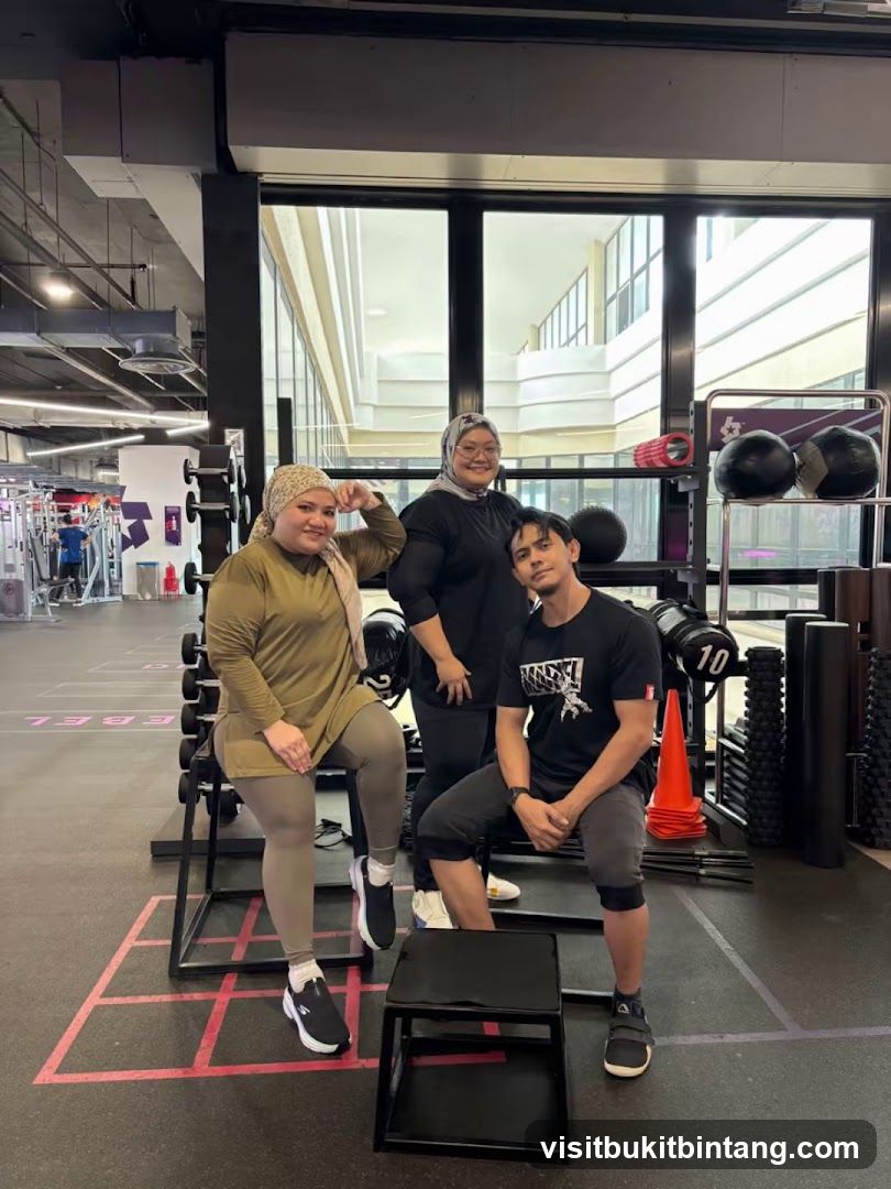 Three people posing in a gym