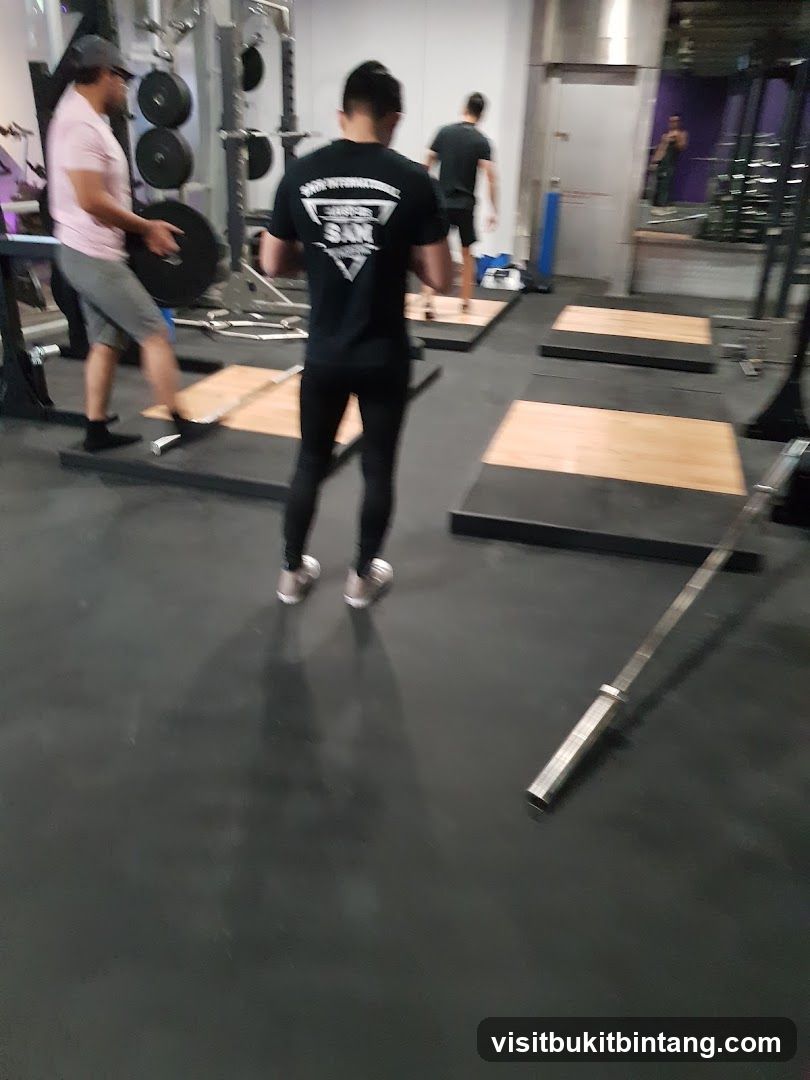 Gym interior with people lifting weights