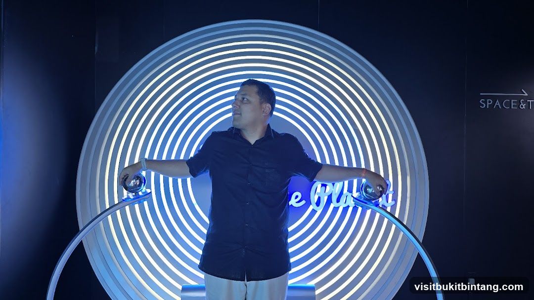 Man Posing with Neon Art Installation