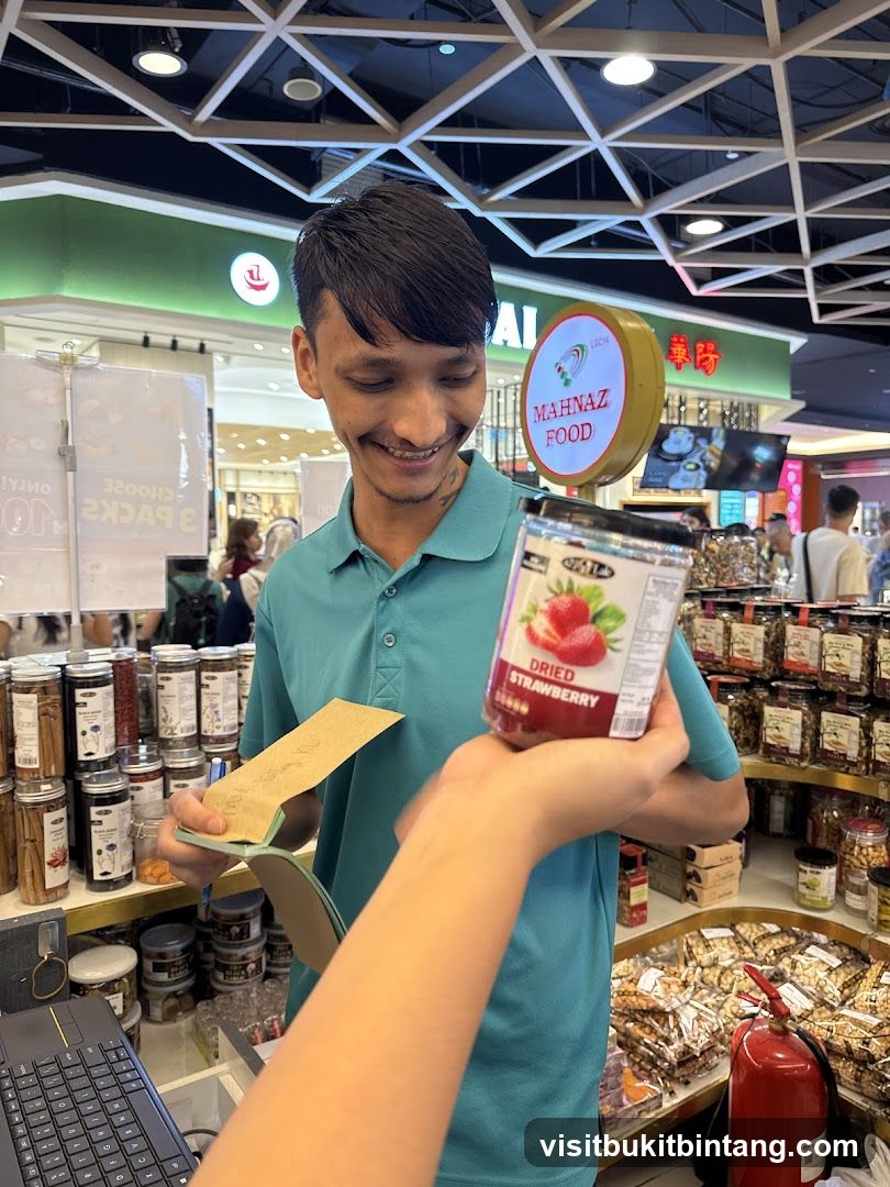 Staff member holding dried strawberries