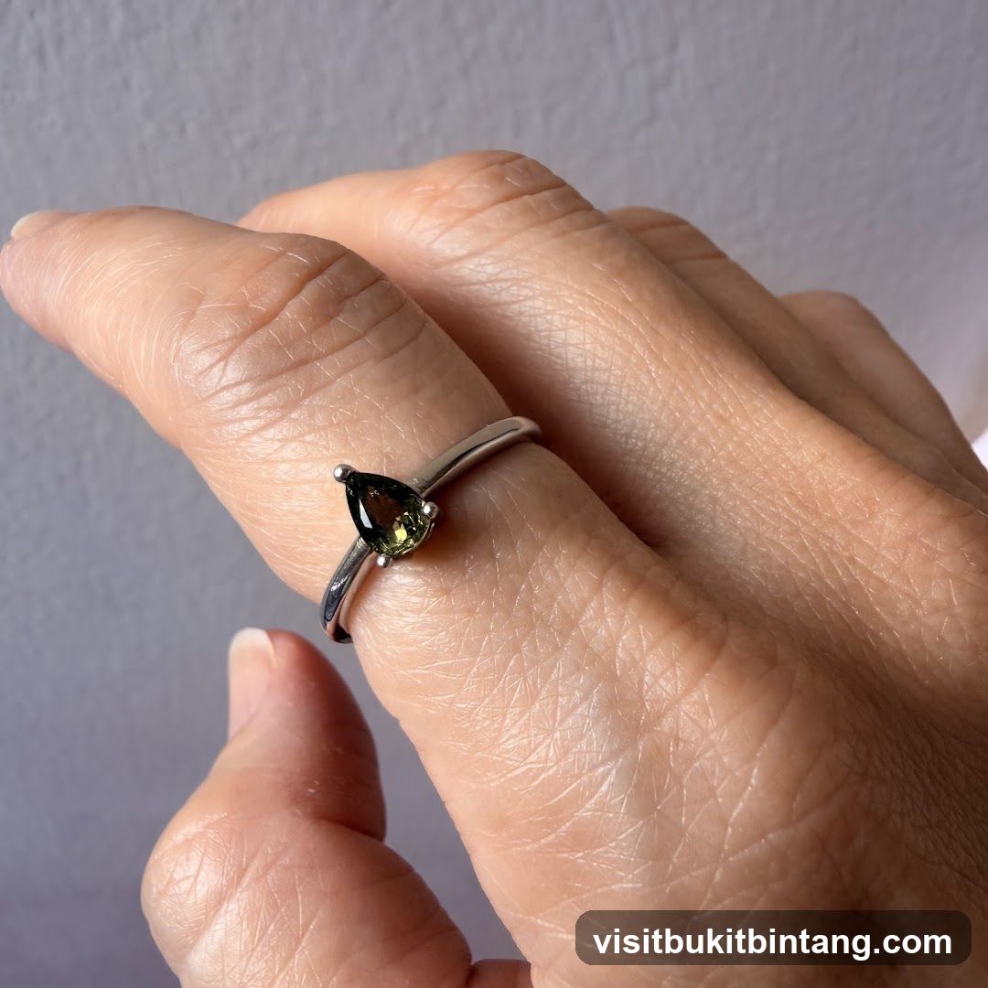 Pear-shaped gemstone ring on a finger
