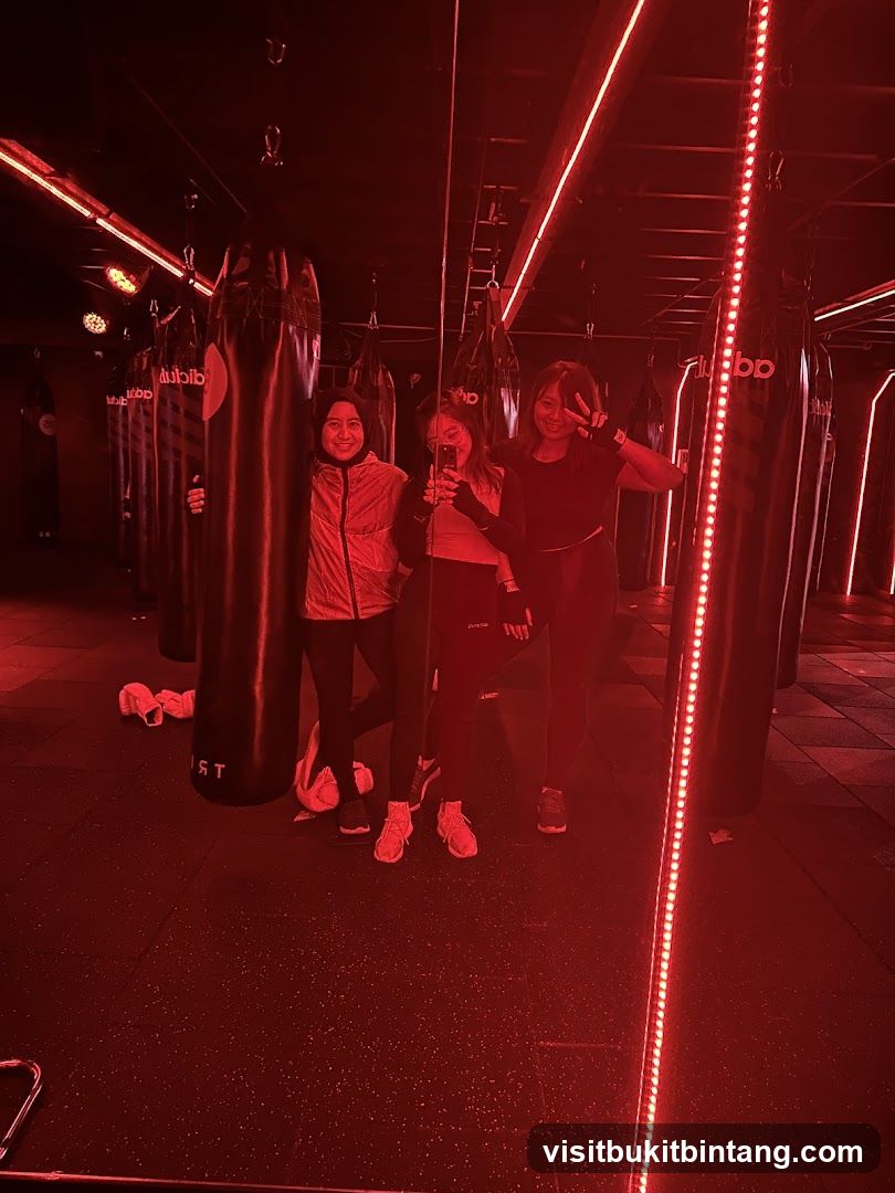 Three women posing in a boxing gym