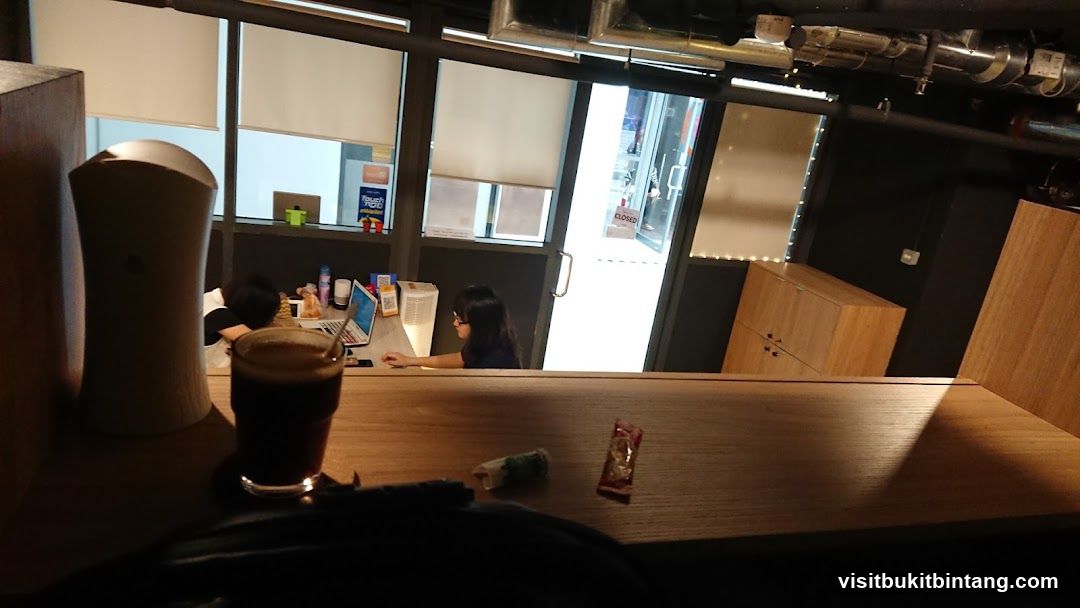 Interior of a cafe with a person working