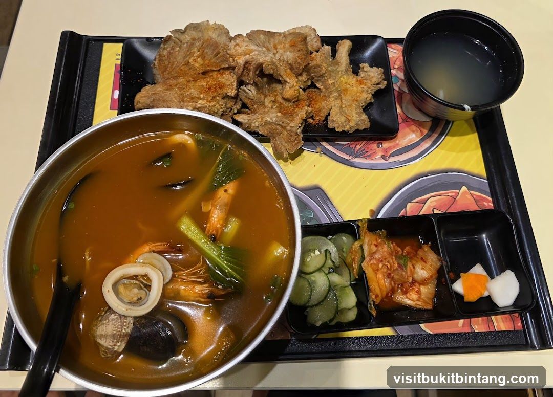 Seafood Noodle Soup with Fried Mushrooms and Side Dishes