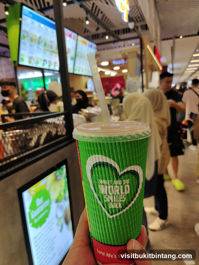 Green cup with straw and heart logo