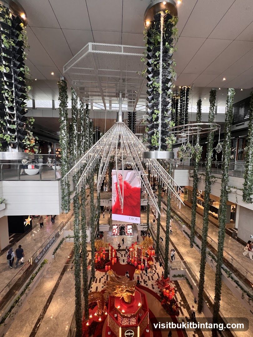 Indoor shopping mall with vertical gardens and festive decorations