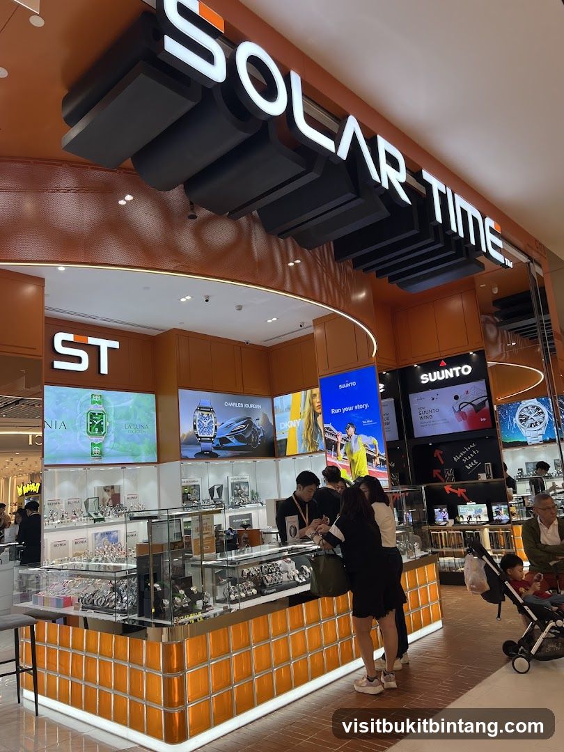 A brightly lit watch store with a prominent "SOLAR TIME" sign above. The store features display cases filled with watches and digital screens showcasing various watch brands and advertisements, including Charles Jourdan, DKNY, and Suunto. Several customers are interacting with staff at the counter.