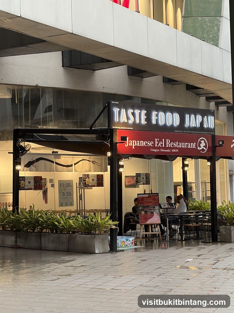 The exterior of a Japanese eel restaurant with prominent signage. The restaurant is called "TASTE FOOD JAPAN" and also "Japanese Eel Restaurant Unagiya Edonadai AMON". The operating hours are displayed as 11:30 AM to 9:30 PM.