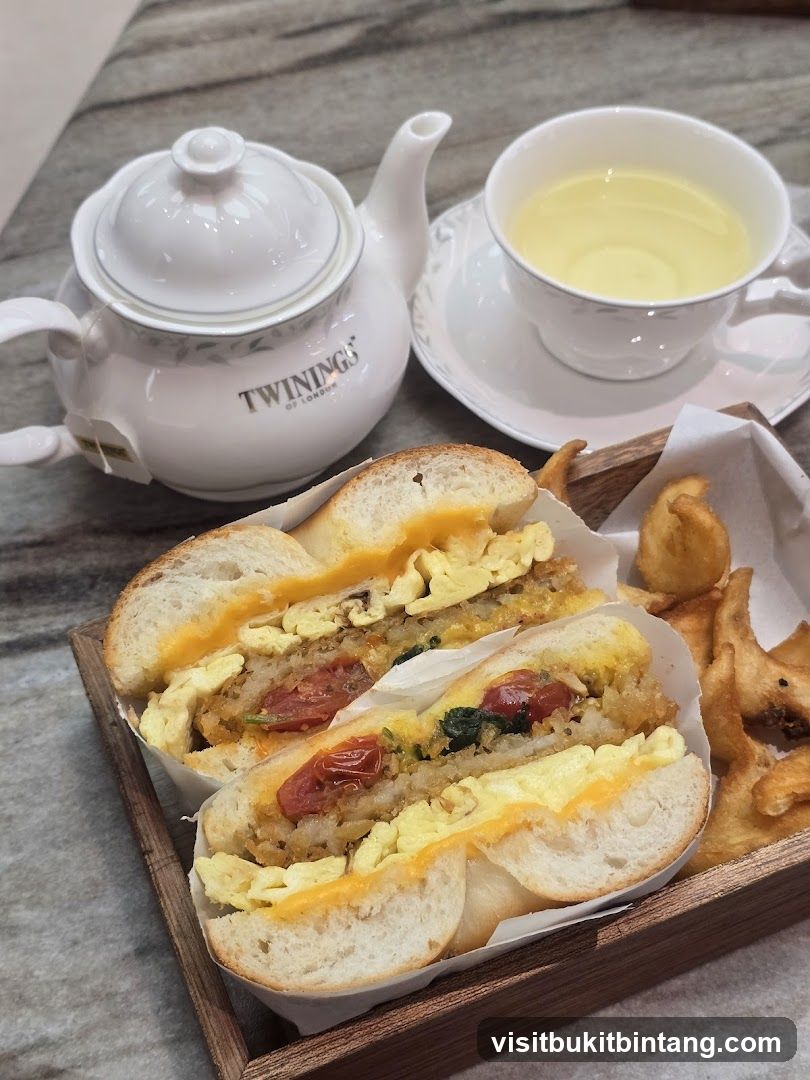 Bagel sandwich with tea and fries