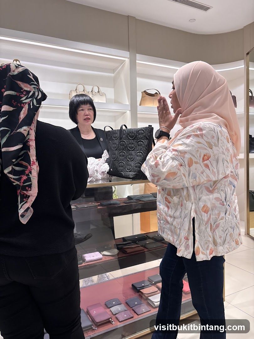 Customers interacting with a sales associate in a luxury goods store