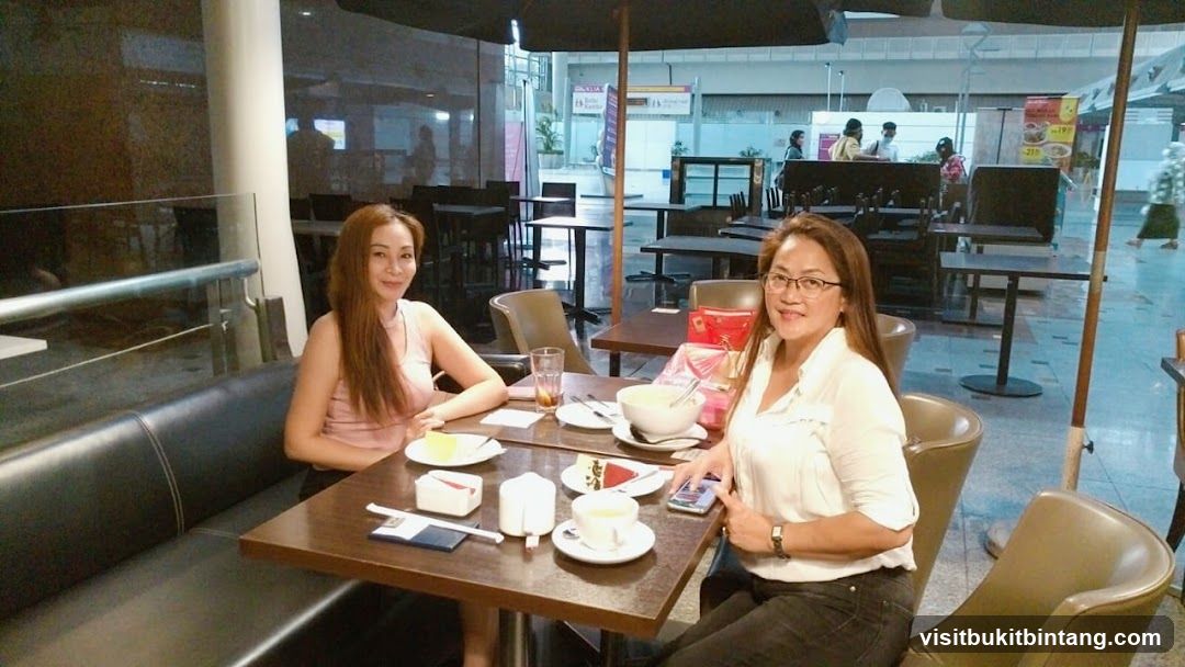Two Women Enjoying Dessert at a Cafe