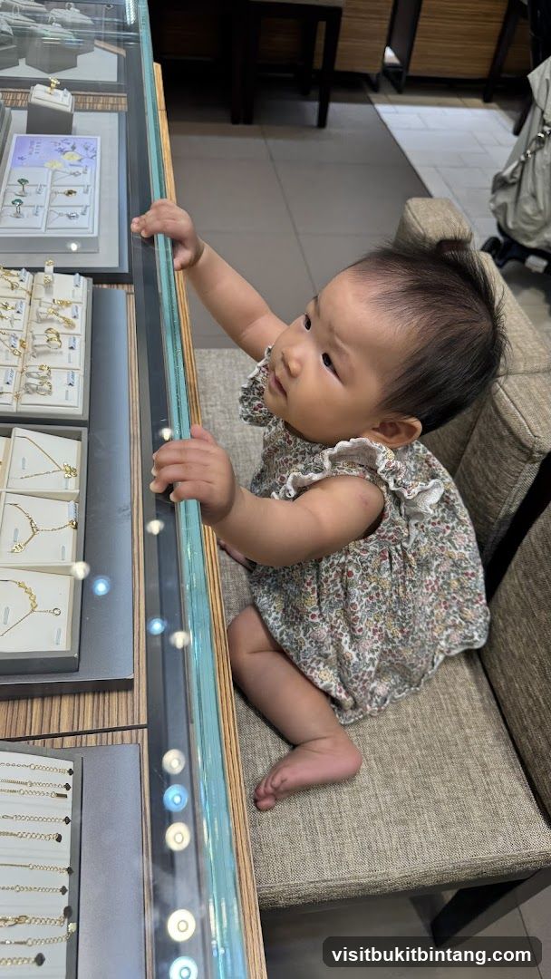 Baby looking at jewelry display