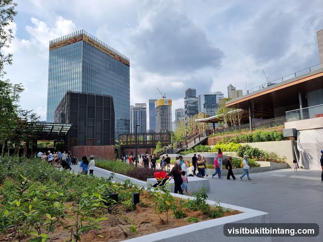 People walking in a modern urban park with skyscrapers in the background
