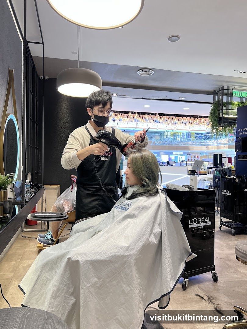 Hairdresser drying client's hair